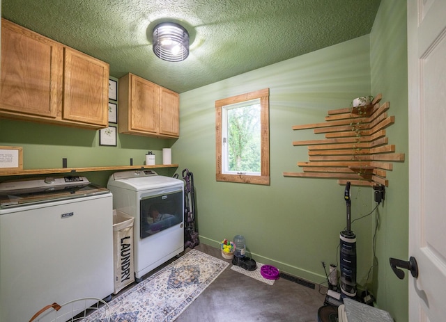 10060 E David Allen Rd, Columbia, MO 65201 - washroom with washing machine and dryer, cabinet space, baseboards, and a textured ceiling