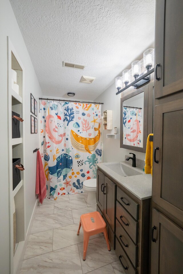 10060 E David Allen Rd, Columbia, MO 65201 - bathroom with marble look tiles, vanity, a textured ceiling, toilet, and a shower with curtain
