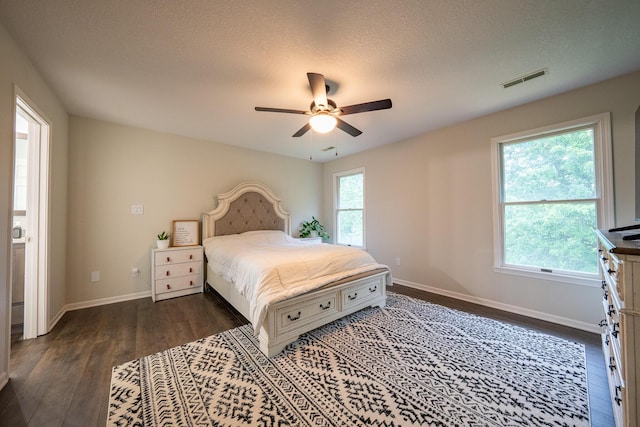 10060 E David Allen Rd, Columbia, MO 65201 - bedroom with dark wood-style flooring, baseboards, ceiling fan, and a textured ceiling