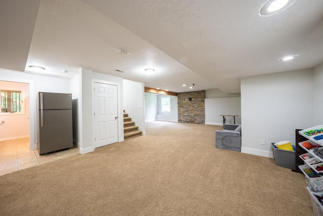 10060 E David Allen Rd, Columbia, MO 65201 - basement with freestanding refrigerator, light carpet, stairway, a textured ceiling, and baseboards