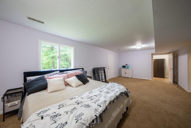 10060 E David Allen Rd, Columbia, MO 65201 - bedroom featuring light carpet, a textured ceiling, and baseboards