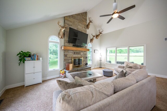 10060 E David Allen Rd, Columbia, MO 65201 - carpeted living area featuring high vaulted ceiling, baseboards, a stone fireplace, and a ceiling fan