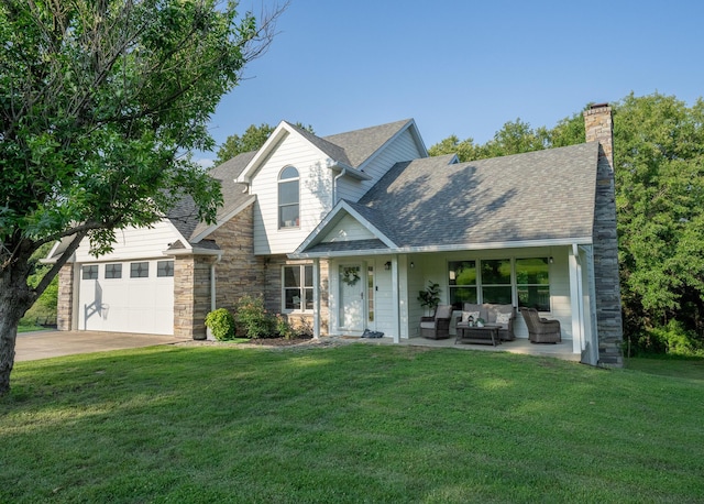 10060 E David Allen Rd, Columbia, MO 65201 - view of front of house featuring a front yard, a garage, a chimney, concrete driveway, and an outdoor living space