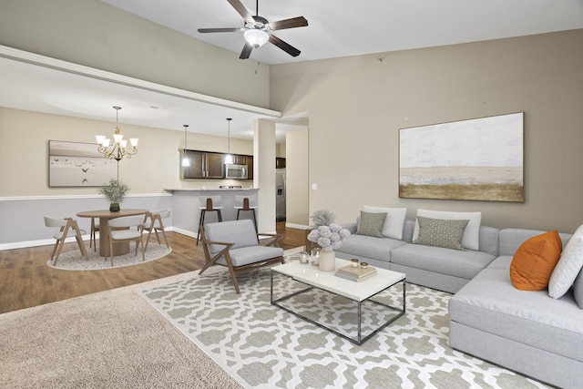 4008 W Worley St Unit 301, Columbia, MO 65203 - living area with a ceiling fan, a chandelier, wood finished floors, and vaulted ceiling