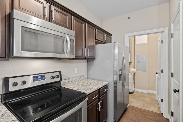 4008 W Worley St Unit 301, Columbia, MO 65203 - kitchen featuring stainless steel appliances, dark brown cabinetry, electric panel, and light stone countertops