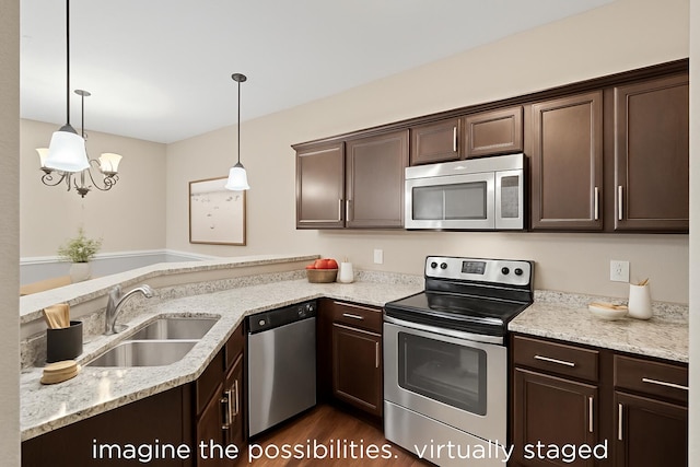 4008 W Worley St Unit 301, Columbia, MO 65203 - kitchen with stainless steel appliances, dark brown cabinets, a peninsula, dark wood-style flooring, and pendant lighting