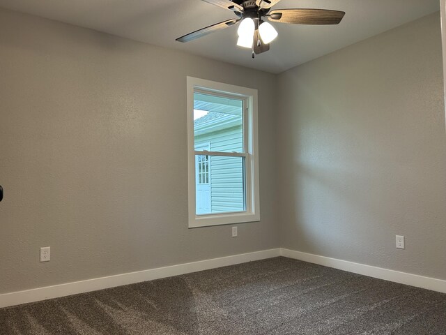 915 Colorado St, Jefferson City, MO 65109 - empty room featuring dark colored carpet, baseboards, and a ceiling fan