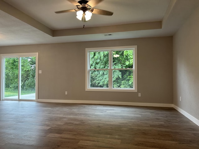 915 Colorado St, Jefferson City, MO 65109 - spare room featuring baseboards, a raised ceiling, and dark wood-type flooring
