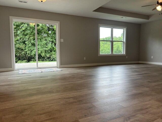 915 Colorado St, Jefferson City, MO 65109 - spare room with healthy amount of natural light, a ceiling fan, wood finished floors, and baseboards