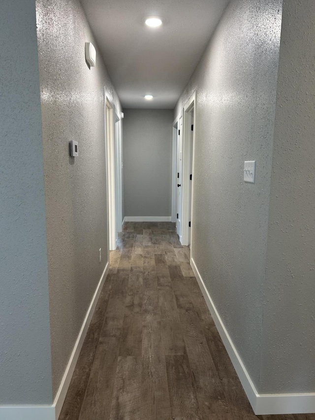 915 Colorado St, Jefferson City, MO 65109 - corridor featuring a textured wall, dark wood-style floors, and baseboards