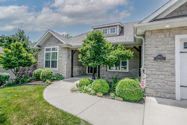 2016 Devonshire Dr, Columbia, MO 65203 - view of front of house featuring stone siding, roof with shingles, and a front yard