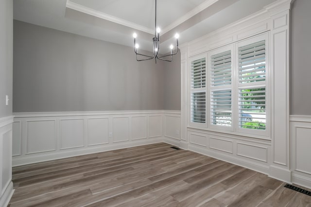 2016 Devonshire Dr, Columbia, MO 65203 - unfurnished dining area featuring ornamental molding, a decorative wall, a chandelier, wood finished floors, and wainscoting