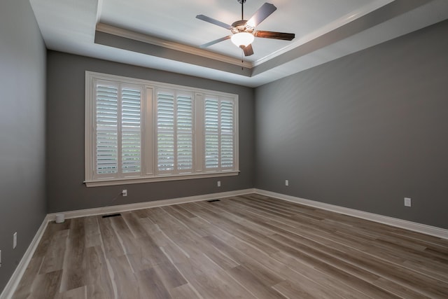 2016 Devonshire Dr, Columbia, MO 65203 - unfurnished room with crown molding, a raised ceiling, ceiling fan, and wood finished floors