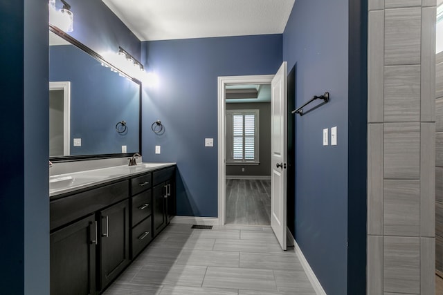2016 Devonshire Dr, Columbia, MO 65203 - bathroom featuring double vanity and baseboards