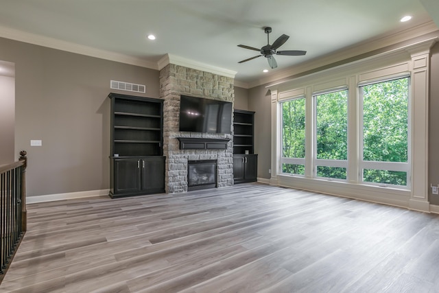 2016 Devonshire Dr, Columbia, MO 65203 - unfurnished living room featuring crown molding, ceiling fan, wood finished floors, a stone fireplace, and recessed lighting