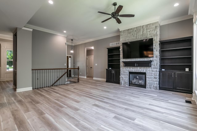 2016 Devonshire Dr, Columbia, MO 65203 - unfurnished living room featuring ceiling fan, crown molding, recessed lighting, wood finished floors, and a stone fireplace