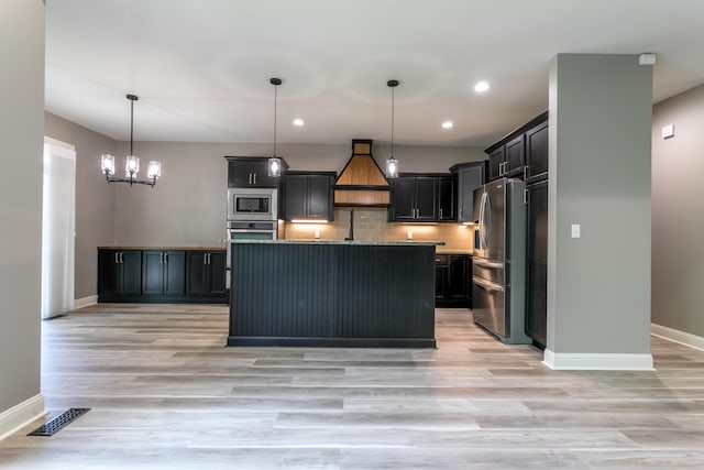 2016 Devonshire Dr, Columbia, MO 65203 - kitchen with appliances with stainless steel finishes, premium range hood, recessed lighting, light wood-style flooring, and decorative backsplash