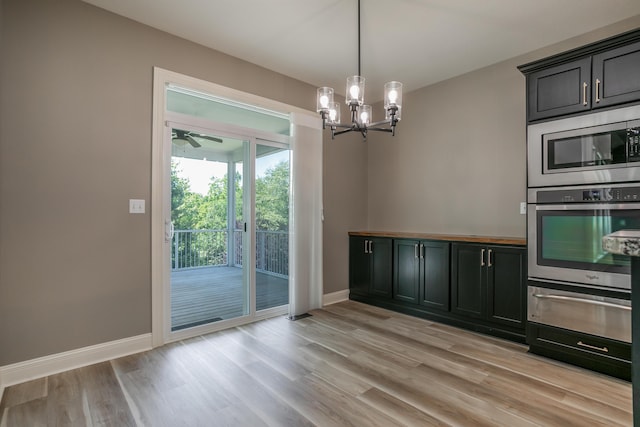 2016 Devonshire Dr, Columbia, MO 65203 - unfurnished dining area featuring a chandelier, light wood finished floors, and ceiling fan
