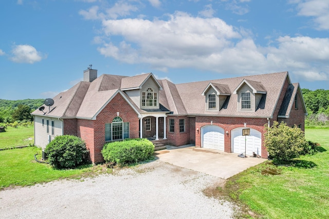 8801 S Ginn Ln, Columbia, MO 65201 - view of front of property featuring brick siding, concrete driveway, a garage, and a front yard