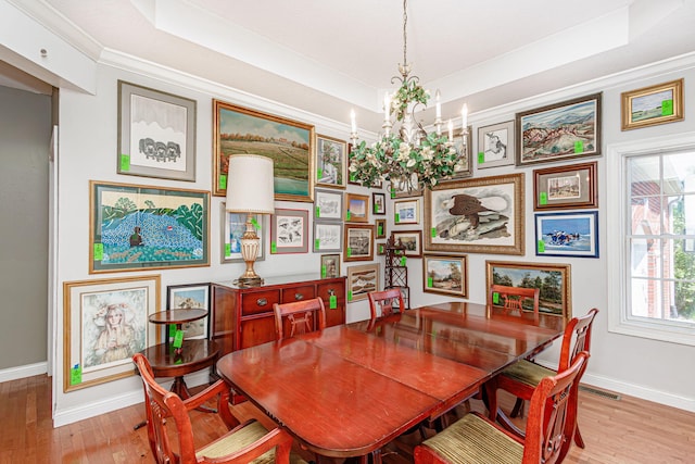 8801 S Ginn Ln, Columbia, MO 65201 - dining room featuring a tray ceiling, baseboards, a chandelier, wood finished floors, and crown molding