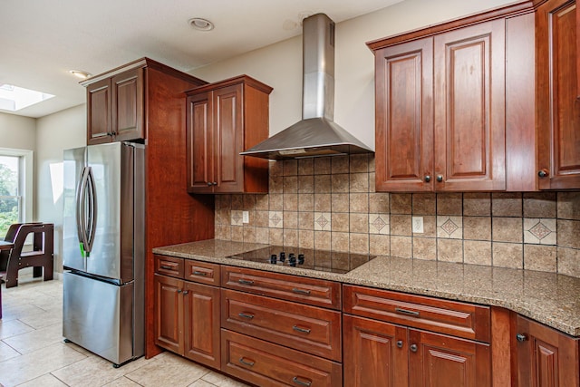 8801 S Ginn Ln, Columbia, MO 65201 - kitchen featuring freestanding refrigerator, wall chimney range hood, black electric cooktop, stone countertops, and recessed lighting