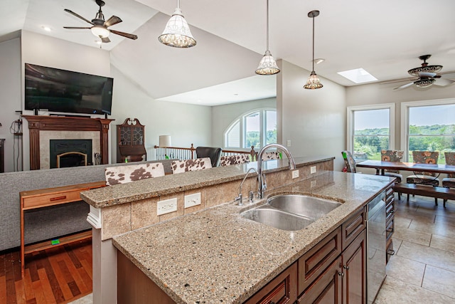8801 S Ginn Ln, Columbia, MO 65201 - kitchen with a sink, ceiling fan, open floor plan, stainless steel dishwasher, and a skylight