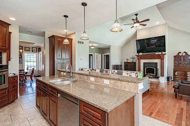 8801 S Ginn Ln, Columbia, MO 65201 - kitchen featuring a sink, stainless steel appliances, open floor plan, an island with sink, and hanging light fixtures