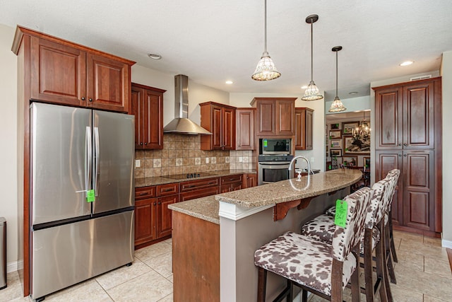 8801 S Ginn Ln, Columbia, MO 65201 - kitchen featuring appliances with stainless steel finishes, wall chimney range hood, decorative backsplash, light stone counters, and a kitchen bar