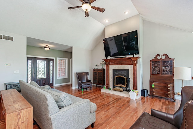 8801 S Ginn Ln, Columbia, MO 65201 - living area with a ceiling fan, vaulted ceiling, a fireplace, wood finished floors, and baseboards