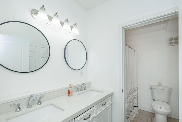 8801 S Ginn Ln, Columbia, MO 65201 - bathroom featuring double vanity, tile patterned flooring, and toilet