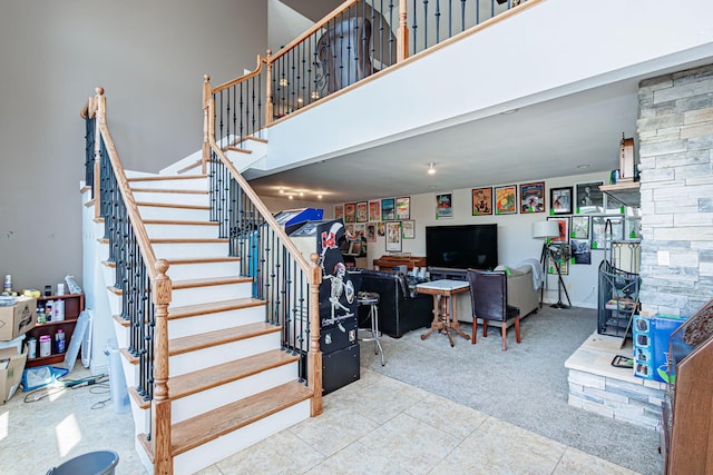 8801 S Ginn Ln, Columbia, MO 65201 - stairs featuring a high ceiling, carpet floors, and tile patterned floors