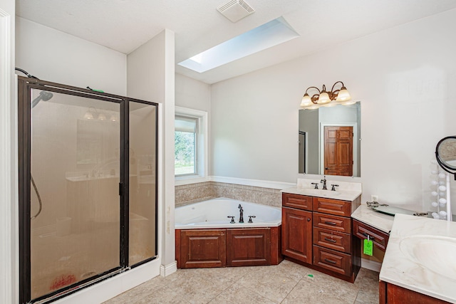8801 S Ginn Ln, Columbia, MO 65201 - bathroom with a skylight, two vanities, a stall shower, a garden tub, and tile patterned flooring
