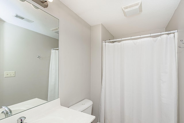 8801 S Ginn Ln, Columbia, MO 65201 - bathroom with toilet, vanity, and a shower with shower curtain