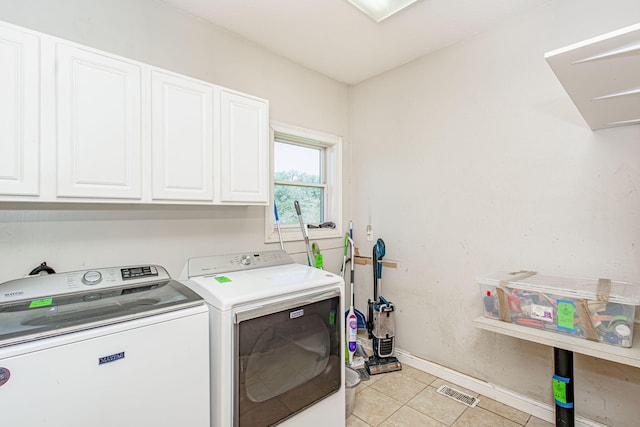 8801 S Ginn Ln, Columbia, MO 65201 - laundry room with cabinet space, independent washer and dryer, light tile patterned floors, and baseboards