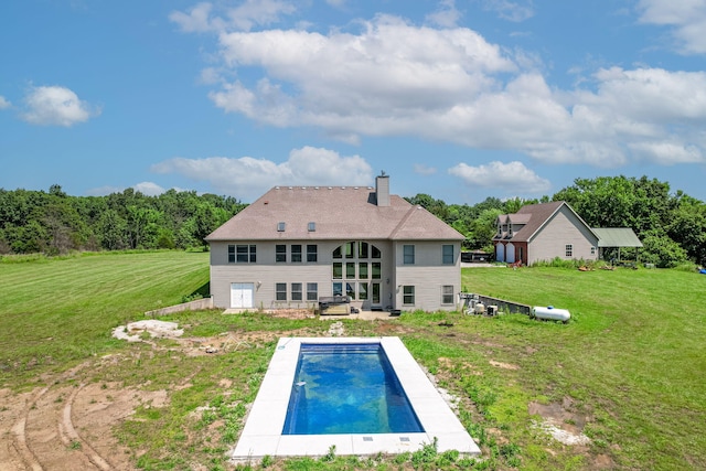 8801 S Ginn Ln, Columbia, MO 65201 - rear view of property featuring a chimney, an outdoor pool, and a lawn