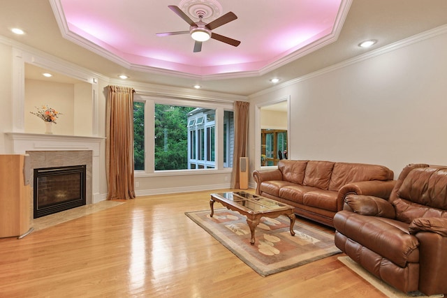 203 Foxwood Ct, Columbia, MO 65203 - living area featuring a raised ceiling, a ceiling fan, light wood finished floors, crown molding, and a fireplace