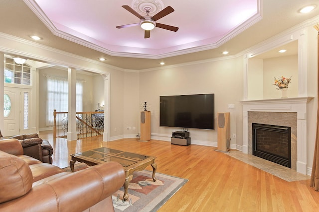 203 Foxwood Ct, Columbia, MO 65203 - living room with a tray ceiling, a ceiling fan, light wood-style flooring, ornamental molding, and a fireplace