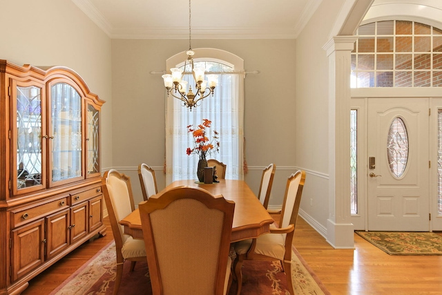 203 Foxwood Ct, Columbia, MO 65203 - dining room with a chandelier, wood finished floors, and crown molding