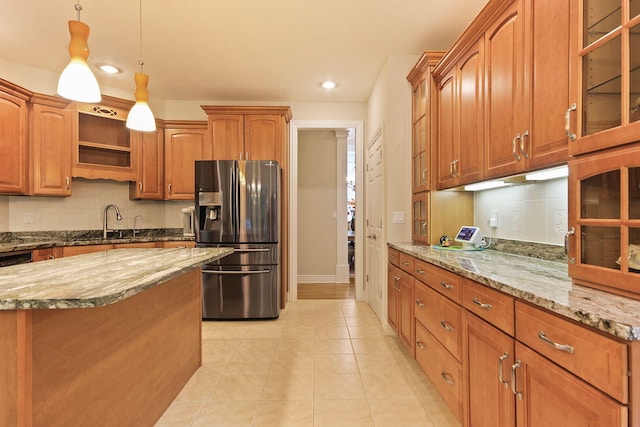 203 Foxwood Ct, Columbia, MO 65203 - kitchen featuring stainless steel fridge, recessed lighting, light stone counters, decorative light fixtures, and glass insert cabinets
