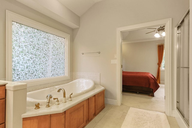 203 Foxwood Ct, Columbia, MO 65203 - ensuite bathroom featuring a garden tub, a ceiling fan, tile patterned floors, and vaulted ceiling