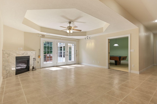203 Foxwood Ct, Columbia, MO 65203 - unfurnished living room featuring a raised ceiling, ceiling fan, light tile patterned floors, french doors, and billiards