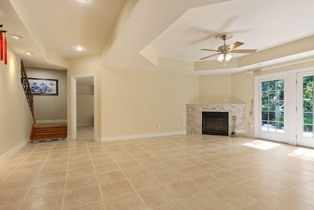 203 Foxwood Ct, Columbia, MO 65203 - unfurnished living room featuring a tray ceiling, ceiling fan, a premium fireplace, and recessed lighting