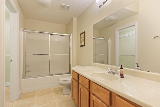 203 Foxwood Ct, Columbia, MO 65203 - bathroom with vanity, enclosed tub / shower combo, a spacious closet, and tile patterned flooring