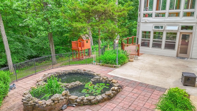 203 Foxwood Ct, Columbia, MO 65203 - fenced backyard with a garden pond, a patio area, and a jacuzzi