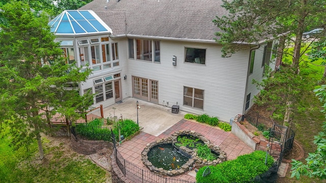 203 Foxwood Ct, Columbia, MO 65203 - back of house featuring a patio and roof with shingles
