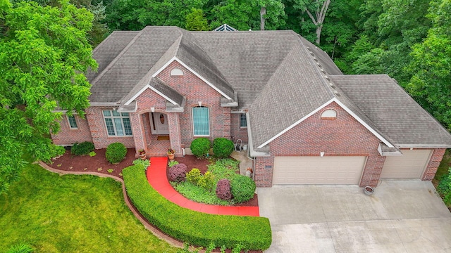 203 Foxwood Ct, Columbia, MO 65203 - traditional-style house with brick siding, an attached garage, roof with shingles, and concrete driveway