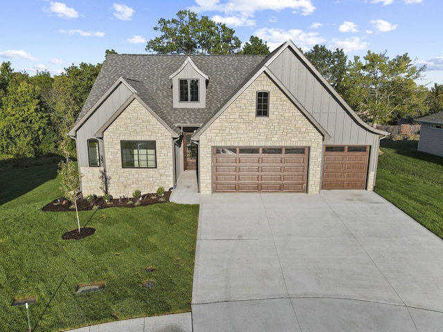 1704 Stillpoint Ct, Columbia, MO 65203 - view of front of property featuring stone siding, board and batten siding, concrete driveway, roof with shingles, and a front yard