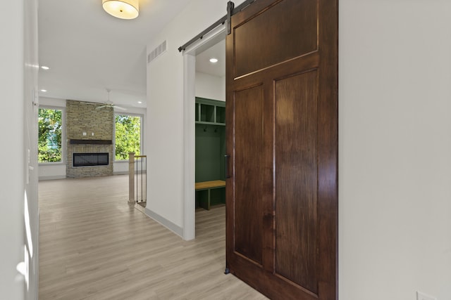 1704 Stillpoint Ct, Columbia, MO 65203 - hallway featuring light wood-type flooring, recessed lighting, and a barn door