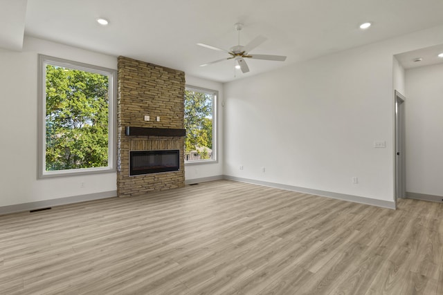 1704 Stillpoint Ct, Columbia, MO 65203 - unfurnished living room with light wood-style flooring, a fireplace, ceiling fan, and recessed lighting