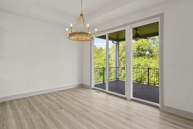 1704 Stillpoint Ct, Columbia, MO 65203 - spare room featuring plenty of natural light, wood finished floors, and a chandelier